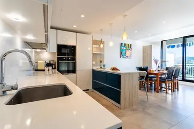 a kitchen with a sink and a dining room at VUE DES ANGES AP4238 By Riviera Holiday Homes in Nice
