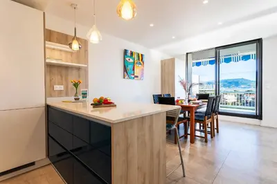 a kitchen and dining room with a table and chairs at VUE DES ANGES AP4238 By Riviera Holiday Homes in Nice