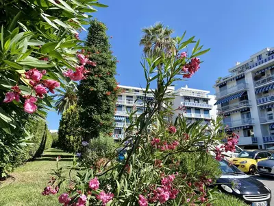 a garden with pink flowers in front of a building at VUE DES ANGES AP4238 By Riviera Holiday Homes in Nice