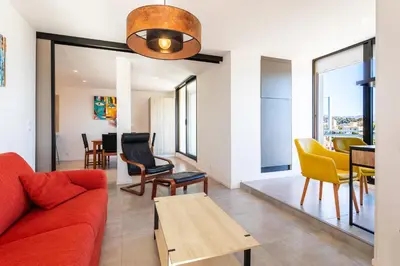 a living room with a red couch and yellow chairs at VUE DES ANGES AP4238 By Riviera Holiday Homes in Nice