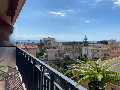 a balcony with a view of a city at Stylish Modern Beach Studio in Nice