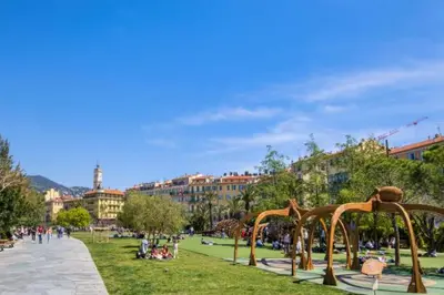 a park with people sitting on the grass at Stylish Modern Beach Studio in Nice