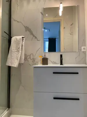 a bathroom with a white sink and a mirror at Spacious 3 BR flat Nice center - magnificent view in Nice