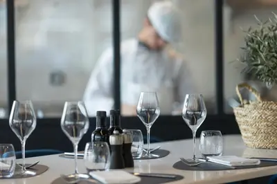 a row of tables with glasses and wine bottles at Hotel Indigo Cagnes-sur-Mer by IHG in Cagnes-sur-Mer