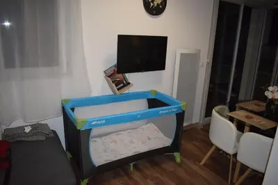a toy crib in a room with a flat screen tv at Nice, là côté magique in Nice