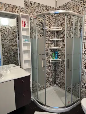a bathroom with a shower with a glass door at Beaulieu Sur Mer: Superbe Appart avec vue Mer in Beaulieu-sur-Mer