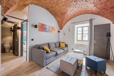 a living room with a couch and a table at Superbe Appartement Au Coeur du Vieux Nice ! in Nice