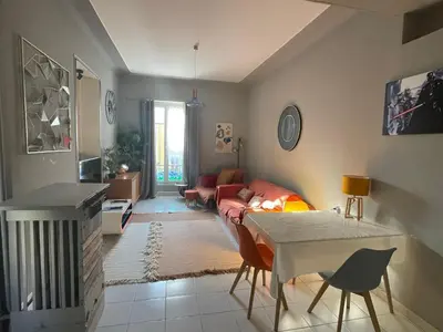 a living room with a couch and a table at Appartement au centre de Nice in Nice