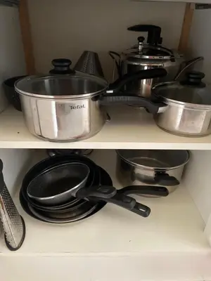 a shelf filled with pots and pans and utensils at Appartement au centre de Nice in Nice