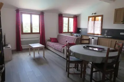 a living room with a couch and a table at 2P entre mer et montagne in Gattières