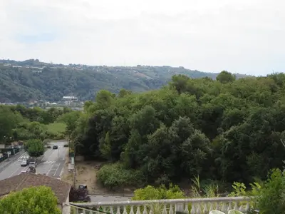 a view of a road and trees in a town at 2P entre mer et montagne in Gattières