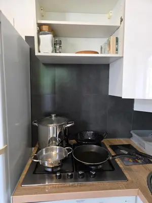 a kitchen with two pots and pans on a stove at 2 spacious bedrooms near Riquier station! in Nice