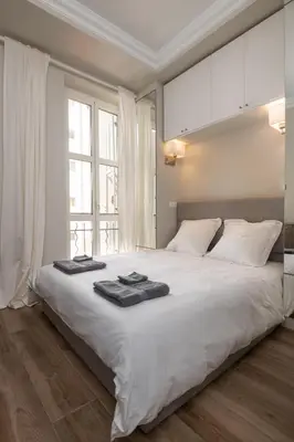 a bedroom with a large white bed with towels on it at 
