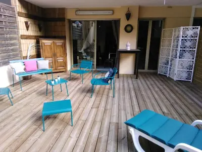 a room with blue chairs and tables on a wooden floor at NICE- GAIRAUT - JARDIN PRIVE- GRAND F1 LUMINEUX-Piscine Collective in Nice