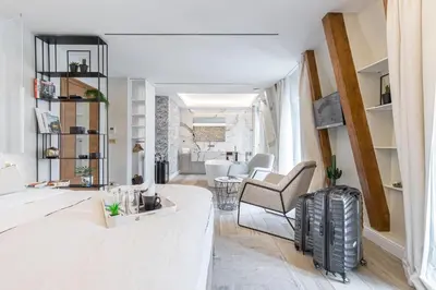 a living room with a couch and a chair at Le Dortoir Boutique Suites in Nice