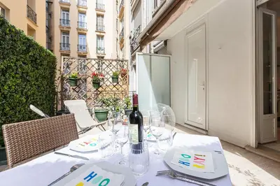 a table with a bottle of wine on top of it at FEEL HOME - GRIMALDI in Nice