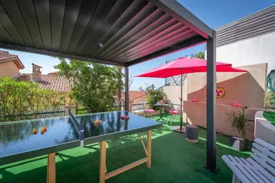 a patio with a table and an umbrella at Villa Panorama in Èze