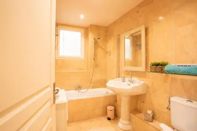 a bathroom with a sink and a tub and a toilet at LE FOCH AP4244 By Riviera Holiday Homes in Nice