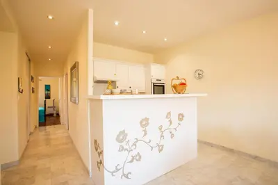 a kitchen with white cabinets and a counter at LE FOCH AP4244 By Riviera Holiday Homes in Nice