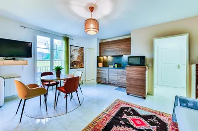 a kitchen and dining room with a table and chairs at La Providence in Nice