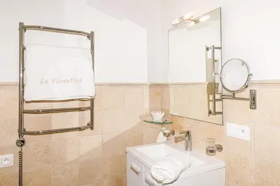 a bathroom with a sink and a mirror at Sea View Apartment with Private Secure Parking 1 in Villefranche-sur-Mer
