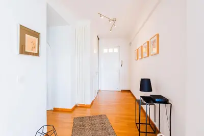 a living room with white walls and a hard wood floor at Terrace on the Bay 2 Villefranche-sur-Mer, AP4243 by Riviera Holiday Homes in Villefranche-sur-Mer