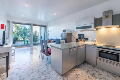 a kitchen with white cabinets and a counter top at Happyfew Eros in Nice