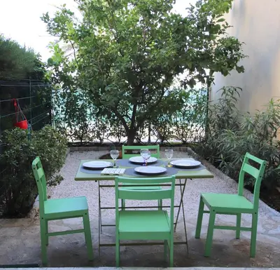 a table and two chairs and a table and chairs at Happyfew Eros in Nice