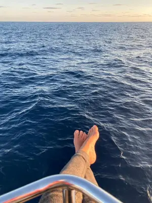 a person sitting on a boat in the water at Great and light private room in the heart of Nice in Nice