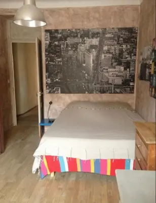 a bedroom with a bed with a painting on the wall at Great and light private room in the heart of Nice in Nice