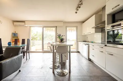 a kitchen with a table in the middle of it at Le Syrius in Nice