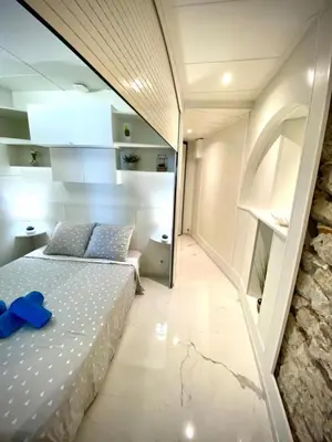 a bedroom with a bed with a blue object on it at LE ROCAMARE -Superb-Atypical Sea view-A.C-WIFI in Nice
