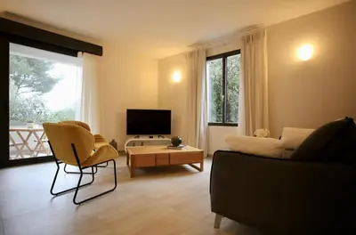 a living room with a couch and a table at Villa LE CIEL D EZE in Èze