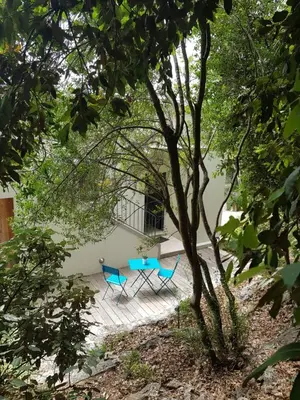 two blue chairs sitting on a porch under a tree at Villa LE CIEL D EZE in Èze