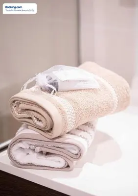 a pile of towels sitting on a counter in a bathroom at Anicesleep Superbe appart au calme et à 5 mn de la Prom in Nice