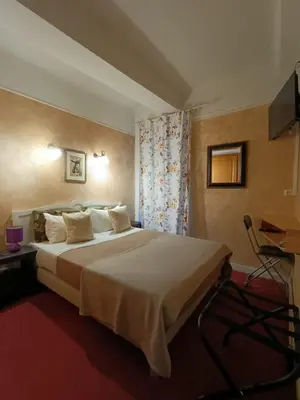 a room with two tables and a potted plant on a counter at Hotel Villa La Tour in Nice