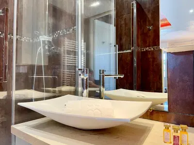 a bathroom with two sinks and a shower at Swiss Star - Easy Home Booking in Nice