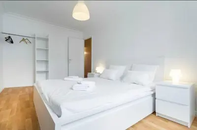 a white bedroom with a large white bed with white pillows at BIG WHITE in Nice