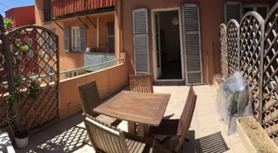 a patio with a table and chairs on a balcony at BIG WHITE in Nice