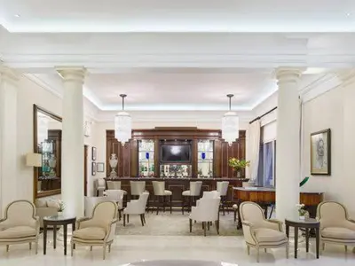 a lobby with a dining area with tables and chairs at Hotel Cap Estel in Èze
