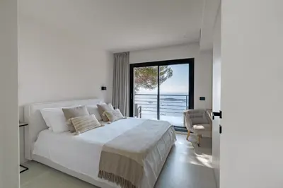 a bedroom with a bed and a view of the ocean at Villa Vista Mare by iVillamia com in Villefranche-sur-Mer