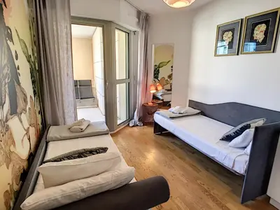 a living room with a bed and a couch at Nestor&Jeeves - PALAIS MEDITERRANEE TERRASSE - Central - Very close sea in Nice