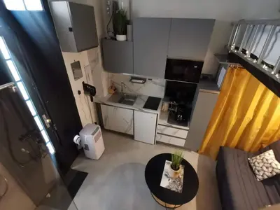 a small apartment with a table and a kitchen at Studette 