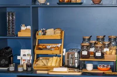 a kitchen counter with many jars of food on it at Aparthotel AMMI Nice Massena - ex Ajoupa in Nice