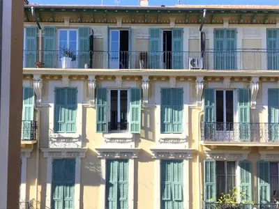 a facade of an apartment building with windows at Modern, traditional , bright and stylish appartement in Nice