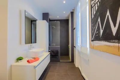 a bathroom with a sink and a mirror at Victor Hugo Palais AP3061 by Riviera Holiday Homes in Nice