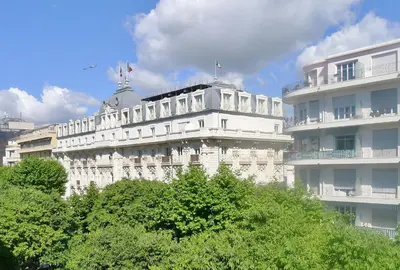 a large white building with trees in front of it at Victor Hugo Palais AP3061 by Riviera Holiday Homes in Nice