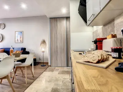 a kitchen and living room with a table and chairs at Nestor&Jeeves - CACTUS RIVIERA - Hyper center - Very close sea and Place Massena in Nice