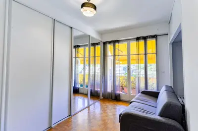 a living room with a couch and some windows at Le Béryl in Nice