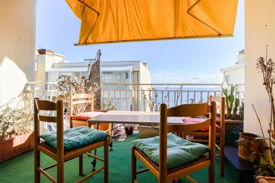 a patio with a table and chairs on a balcony at Le Béryl in Nice